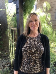 Woman wearing an animal print shirt and black cardigan